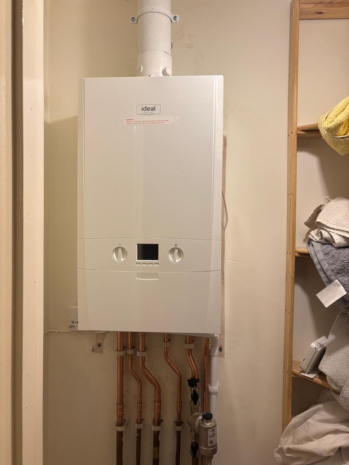 Compact Ideal boiler installation in a homeowner's airing cupboard