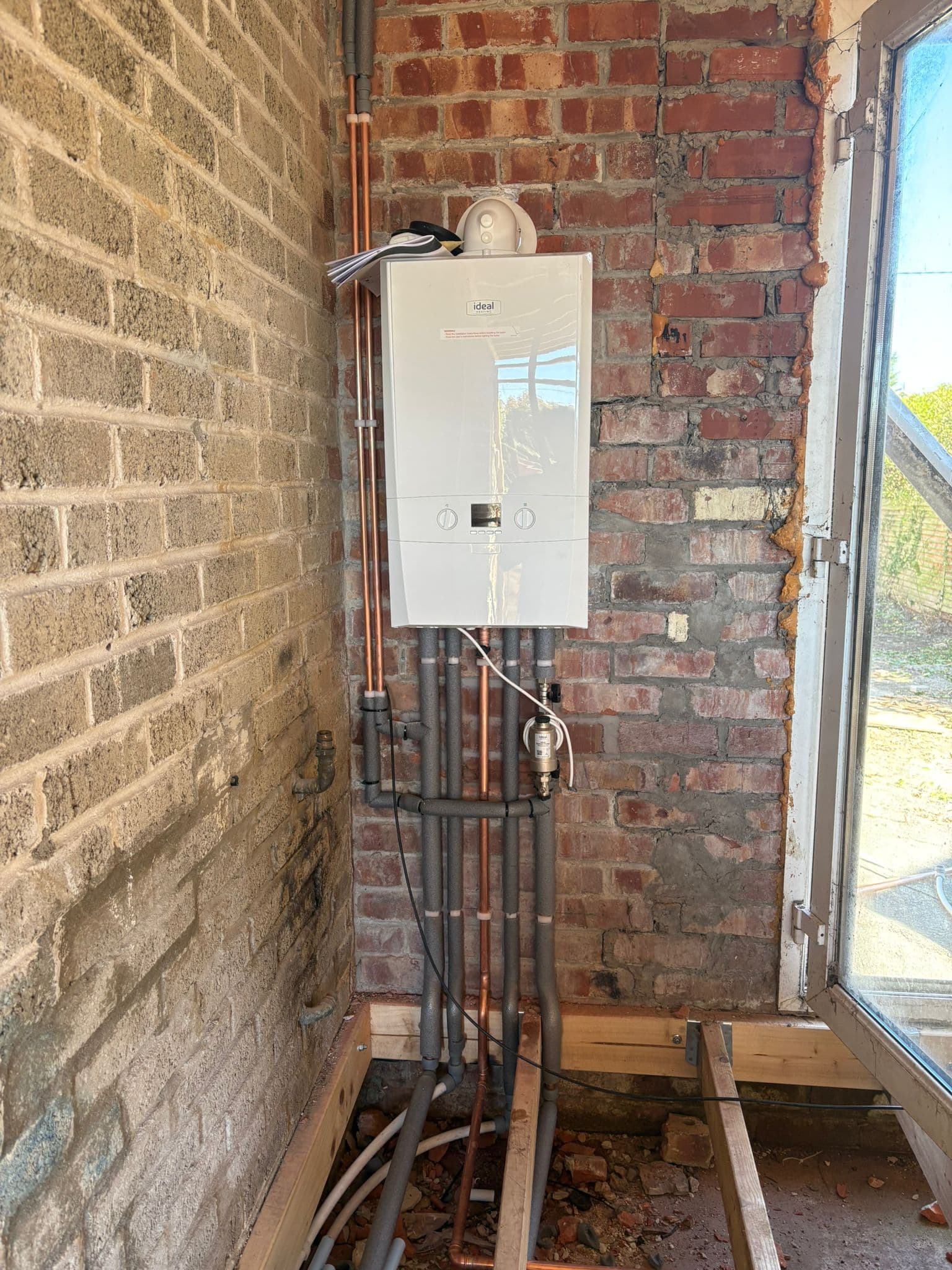 Ideal boiler installed during a property renovation with new pipework before plastering